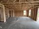 An unfinished interior view showcasing stud framing and windows ready for customization and design at 82 W Emily Gardens Dr, Selma, NC 27577