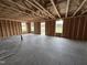 An unfinished interior view showcasing stud framing and windows ready for customization and design at 82 W Emily Gardens Dr, Selma, NC 27577