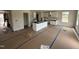 Large open concept kitchen with white cabinets, an island, and natural light at 82 W Emily Gardens Dr, Selma, NC 27576