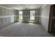 Unfinished main bedroom showcasing large windows, awaits personal touches at 82 W Emily Gardens Dr, Selma, NC 27577