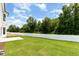 The backyard features a lush, green lawn and a white fence that enhances the property's appeal at 83 W Emily Gardens Dr, Selma, NC 27576