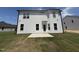 Backyard with cement patio, green grass, and white two-story home at 83 W Emily Gardens Dr, Selma, NC 27576