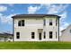 A two-story home with vinyl siding is viewed from the backyard with a well-manicured lawn at 83 W Emily Gardens Dr, Selma, NC 27576