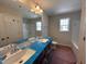 Bright bathroom features a double sink vanity, large mirror, and a window for natural light at 83 W Emily Gardens Dr, Selma, NC 27576