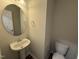 Half bathroom featuring stylish pedestal sink and modern toilet at 83 W Emily Gardens Dr, Selma, NC 27576