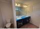 Bathroom features double sink vanity, large mirror and toilet at 83 W Emily Gardens Dr, Selma, NC 27576