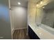 Bathroom with a modern vanity, large mirror, and tiled walk-in shower at 83 W Emily Gardens Dr, Selma, NC 27576