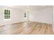 Bright bedroom with wood floors and two windows, providing a comfortable living space at 83 W Emily Gardens Dr, Selma, NC 27576