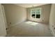 Unfinished bedroom featuring a large window providing natural light at 83 W Emily Gardens Dr, Selma, NC 27576