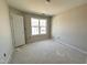 Unfinished bedroom featuring a large window providing natural light at 83 W Emily Gardens Dr, Selma, NC 27576