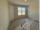 Bedroom with neutral walls, carpet, and a window with a view of the neighborhood at 83 W Emily Gardens Dr, Selma, NC 27576