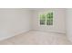 Bright bedroom with plush carpeting and a large window at 83 W Emily Gardens Dr, Selma, NC 27576