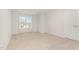 A carpeted bedroom is brightened by a window that offers a view of the neighborhood at 83 W Emily Gardens Dr, Selma, NC 27576