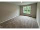 Comfortable bedroom showcasing neutral tones, plush carpeting, and a window view at 83 W Emily Gardens Dr, Selma, NC 27576
