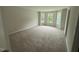 Spacious bedroom with large windows offering ample natural light and plush carpeting at 83 W Emily Gardens Dr, Selma, NC 27576