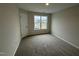 Cozy bedroom with plush carpeting and a bright window overlooking the neighborhood at 83 W Emily Gardens Dr, Selma, NC 27576