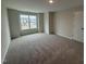 Spacious bedroom with plush carpeting and a large window for natural light at 83 W Emily Gardens Dr, Selma, NC 27576