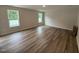 Bedroom featuring wood flooring, natural light from two windows, and neutral wall color at 83 W Emily Gardens Dr, Selma, NC 27576