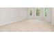 Empty room with a large window, neutral walls, and light beige carpeting at 83 W Emily Gardens Dr, Selma, NC 27576