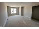 Spacious, unfinished bedroom featuring a large window providing natural light at 83 W Emily Gardens Dr, Selma, NC 27576