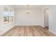 Bright dining room with wood floors and a modern chandelier at 83 W Emily Gardens Dr, Selma, NC 27576