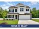 Charming two-story home with white siding, black shutters, and a well-manicured front lawn at 83 W Emily Gardens Dr, Selma, NC 27576