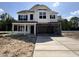 New two-story home with a spacious two-car garage and concrete driveway at 83 W Emily Gardens Dr, Selma, NC 27576