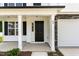 Close-up of front door with sidelight and stone accents, showcasing the home's entry at 83 W Emily Gardens Dr, Selma, NC 27576