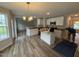 Well-lit kitchen with white cabinets, granite countertops, and a center island at 83 W Emily Gardens Dr, Selma, NC 27576