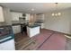 Modern kitchen featuring white cabinets, stainless steel appliances, an island, and granite countertops at 83 W Emily Gardens Dr, Selma, NC 27576