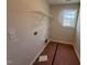 Unfinished laundry room with a window, shelving, and connections for a washer and dryer at 83 W Emily Gardens Dr, Selma, NC 27576