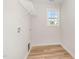 Spacious laundry room with overhead shelving at 83 W Emily Gardens Dr, Selma, NC 27576