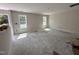 Spacious, unfinished living room with natural light from large windows at 83 W Emily Gardens Dr, Selma, NC 27576