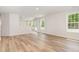 Spacious living room with wood floors and large windows, offering ample natural light at 83 W Emily Gardens Dr, Selma, NC 27576