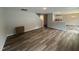 Open-concept living room area with wood flooring and a view to the kitchen at 83 W Emily Gardens Dr, Selma, NC 27576
