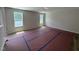 Bright, unfurnished living room with new flooring, neutral paint, and abundant natural light from two windows at 83 W Emily Gardens Dr, Selma, NC 27576