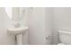 Well-lit powder room features a pedestal sink and modern fixtures at 83 W Emily Gardens Dr, Selma, NC 27576