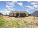 The backyard is large and includes a screened in back porch and recently installed lawn at 87 Tee Dr, Selma, NC 27576