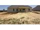 Backyard featuring a covered patio and freshly graded landscape, offering a space for outdoor enjoyment at 87 Tee Dr, Selma, NC 27576