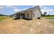 The backyard has an installed air conditioning unit, screened porch, and newly seeded lawn at 87 Tee Dr, Selma, NC 27576