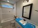 Bathroom with a tiled floor, granite countertops, and a tub with a shower at 87 Tee Dr, Selma, NC 27576