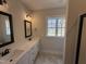 Bathroom featuring dual sinks, quartz countertops, and modern fixtures at 87 Tee Dr, Selma, NC 27576