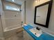 Bathroom featuring a vanity with a sink, a bathtub with a shower, tile flooring, and natural light at 87 Tee Dr, Selma, NC 27576