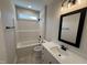 Bathroom featuring a single sink, a shower/tub combo, and modern fixtures at 87 Tee Dr, Selma, NC 27576