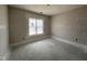 Unfinished bedroom featuring neutral walls, a bright window and concrete flooring awaiting customization at 87 Tee Dr, Selma, NC 27576