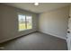 Bedroom with neutral walls, carpeted floors, and a large window at 87 Tee Dr, Selma, NC 27576