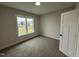 Well-lit bedroom with neutral paint and carpet, ready for customization at 87 Tee Dr, Selma, NC 27576