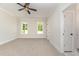 Spacious bedroom featuring plush carpeting, neutral walls, and bright windows at 87 Tee Dr, Selma, NC 27576