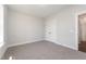 This bedroom offers neutral walls, a large window, and a double door closet at 87 Tee Dr, Selma, NC 27576