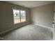 Unfinished bedroom with one large window allowing ample natural light at 87 Tee Dr, Selma, NC 27576